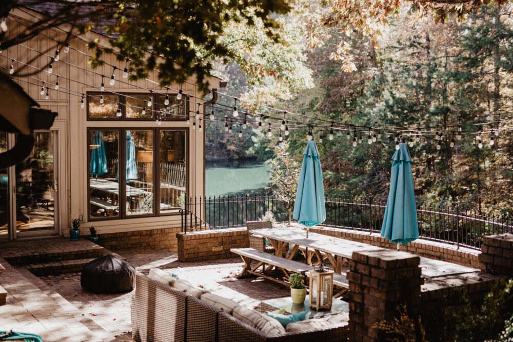 Outdoor porch at group home with furniture next to the water.