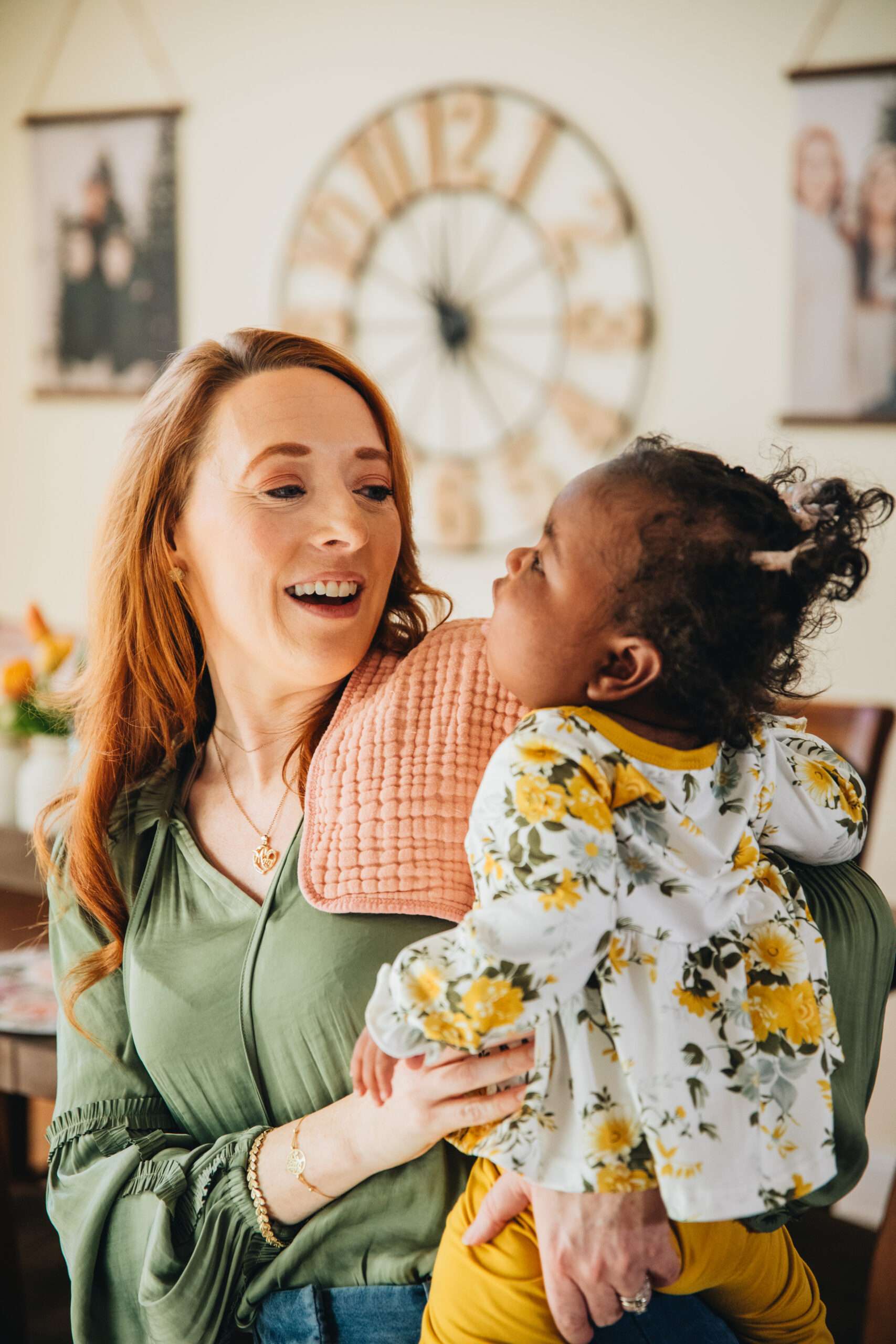 A woman holding a baby while providing parenting tips